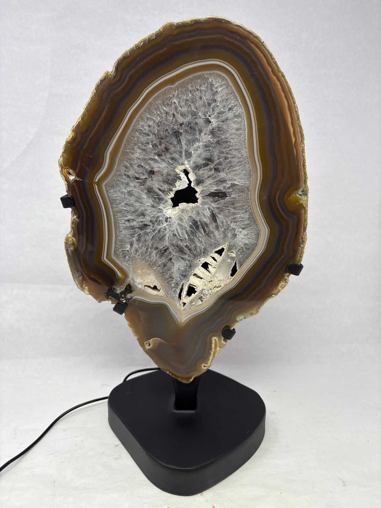 Chocolate Agate Slice with Amethyst Center On Illuminated Table Stand