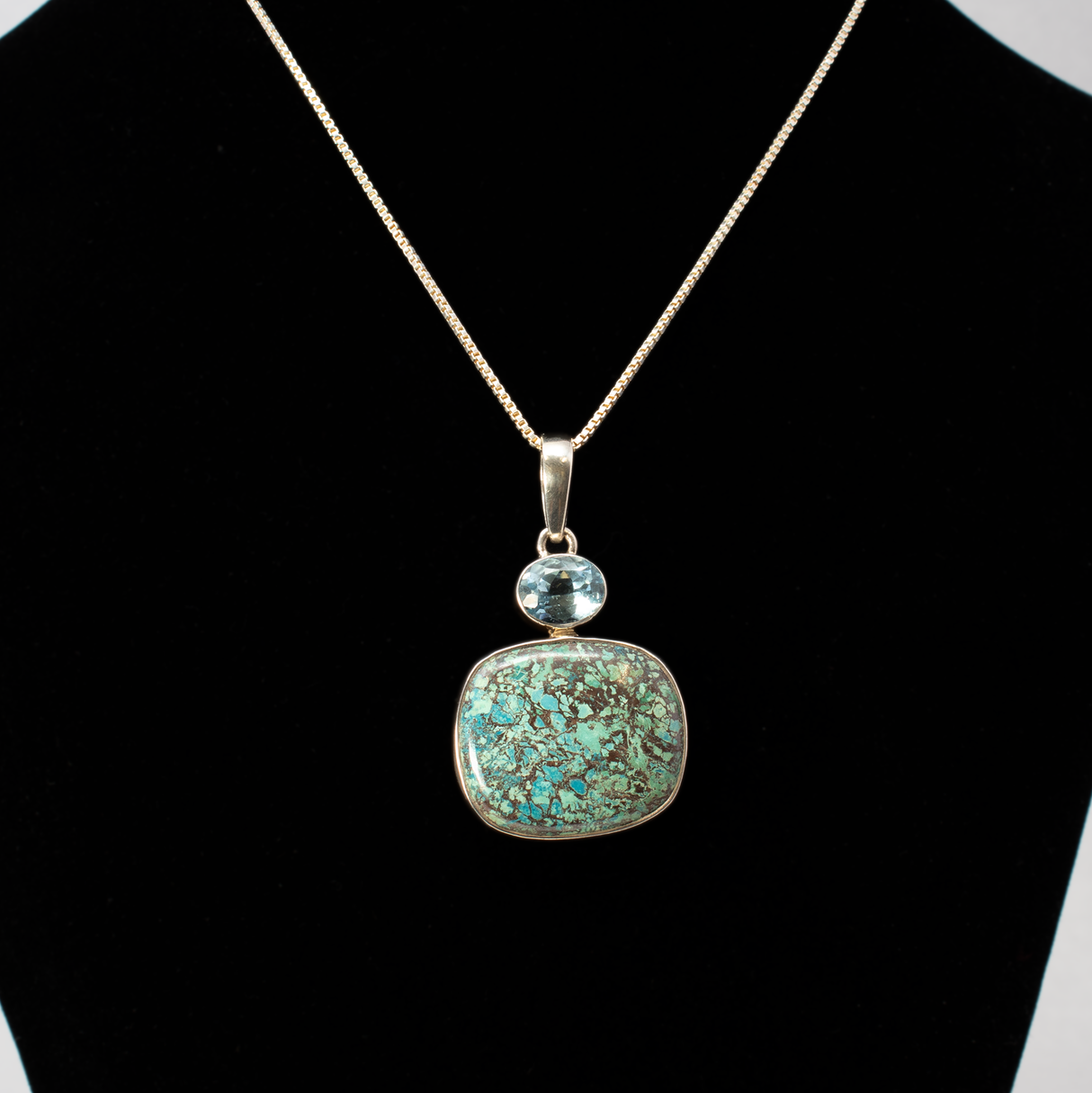 View of Chrysocolla Shattuckite Pendant -Rounded Rectangle With Blue Topaz Oval