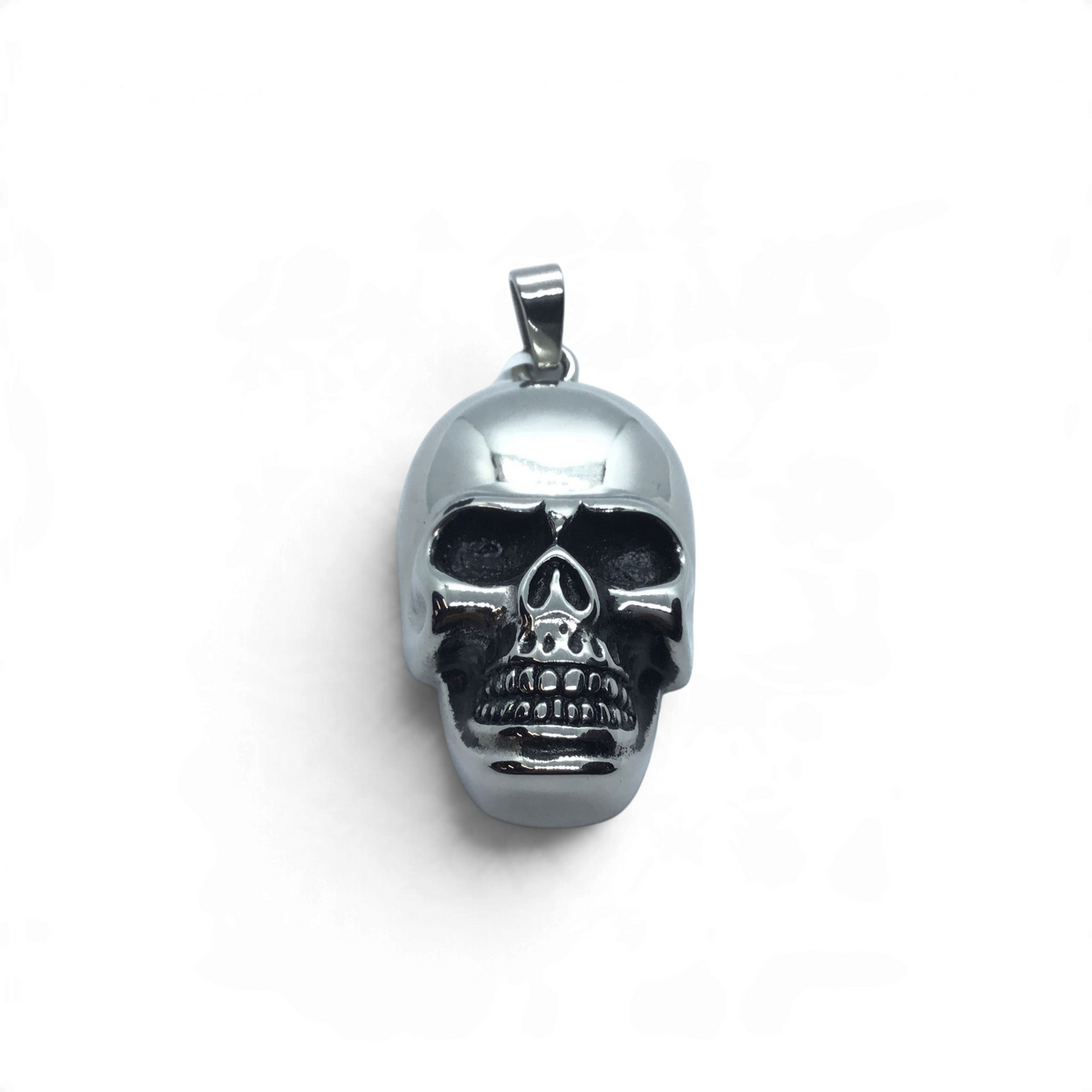 Polished stainless steel skull pendant with detailed teeth and deep eye sockets