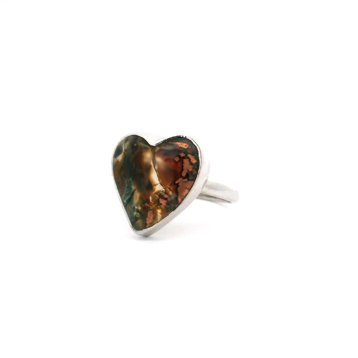 Native copper curved heart cabochon ring with rust and green tones in a simple silver bezel