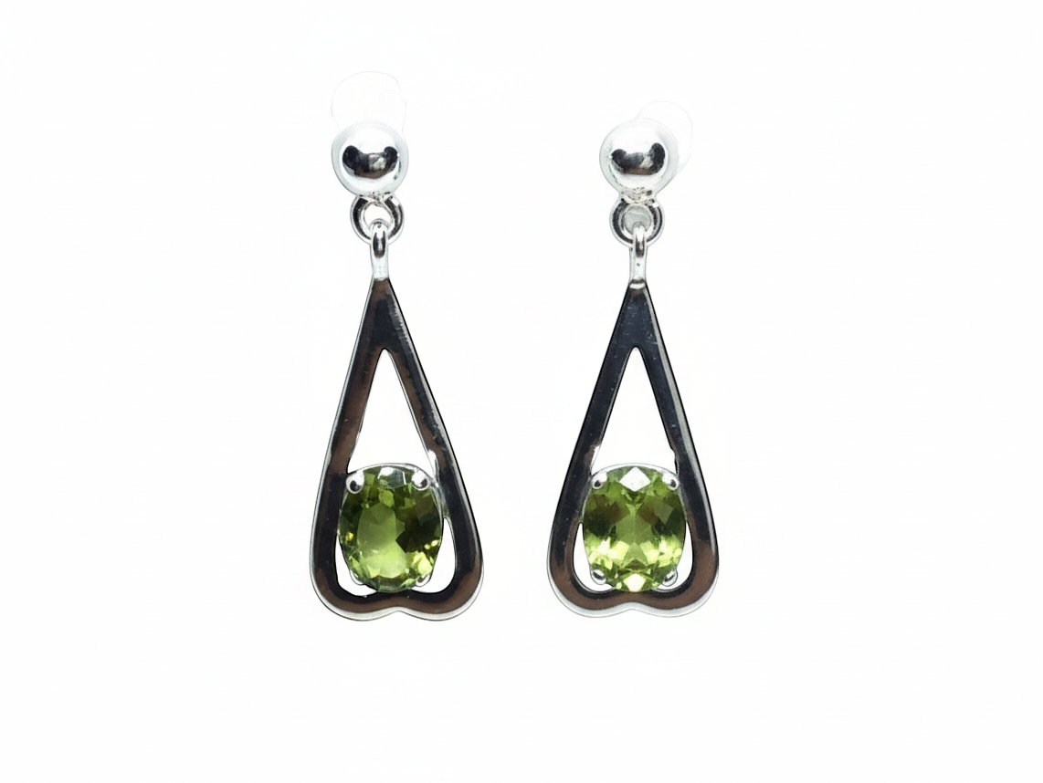 Rare Earth Gallery peridot dangle earrings featuring faceted oval stones in sterling silver reverse heart settings.