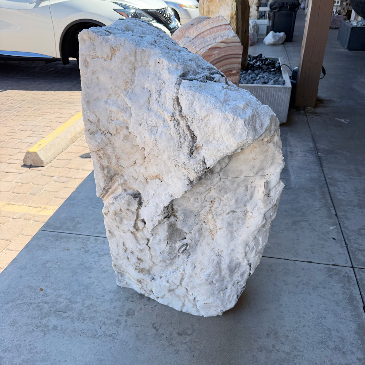 Rough natural back of the zebra onyx fountain showing chalky white and tan stone