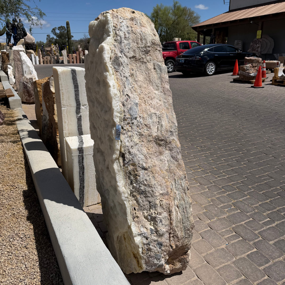 Ice onyx and caliche vertical fountain standing in the gallery yard, white druze face beside tan caliche side