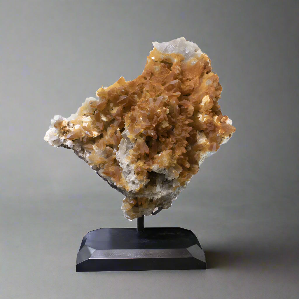 Crystal art on a black stand against a white background