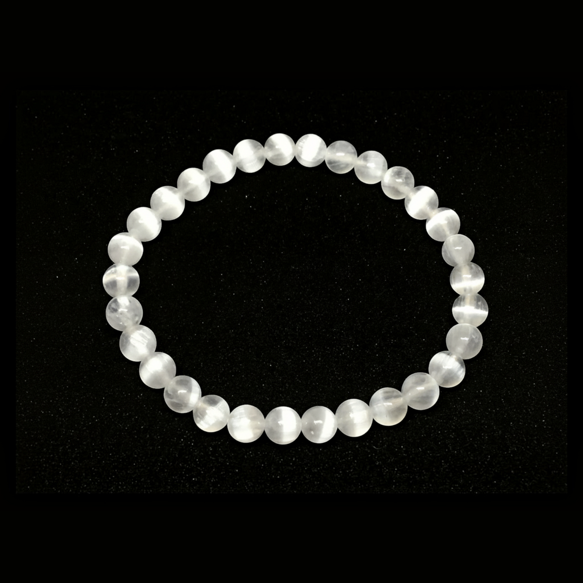 Rare Earth Gallery 6mm selenite beaded bracelet with translucent white crystal beads on a white background