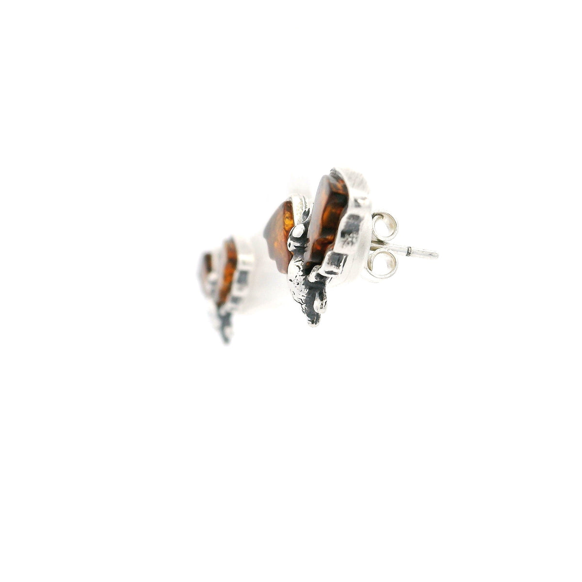 Cognac amber bat stud earrings shown from the side with sterling silver posts and amber wings