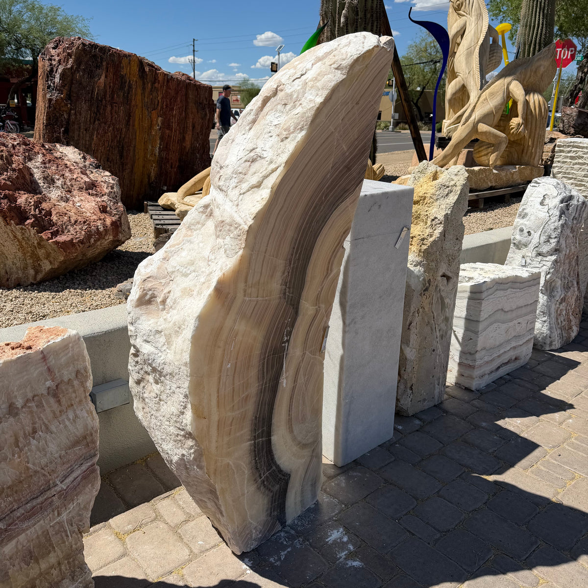 Polished face of the Cosmic Sunset Fossil Zebra Onyx pillar fountain, crescent bands of tan, cream and brown