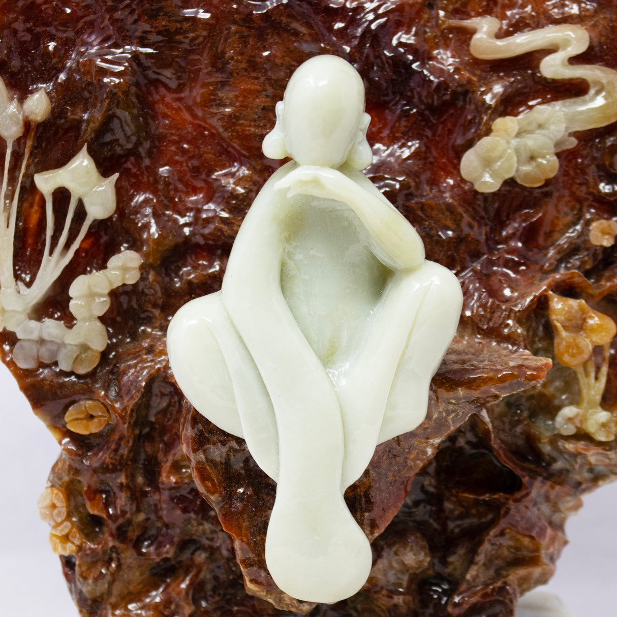 Green Jade Buddha Sculpture Sitting on Brown Jade Relieved Back Drop