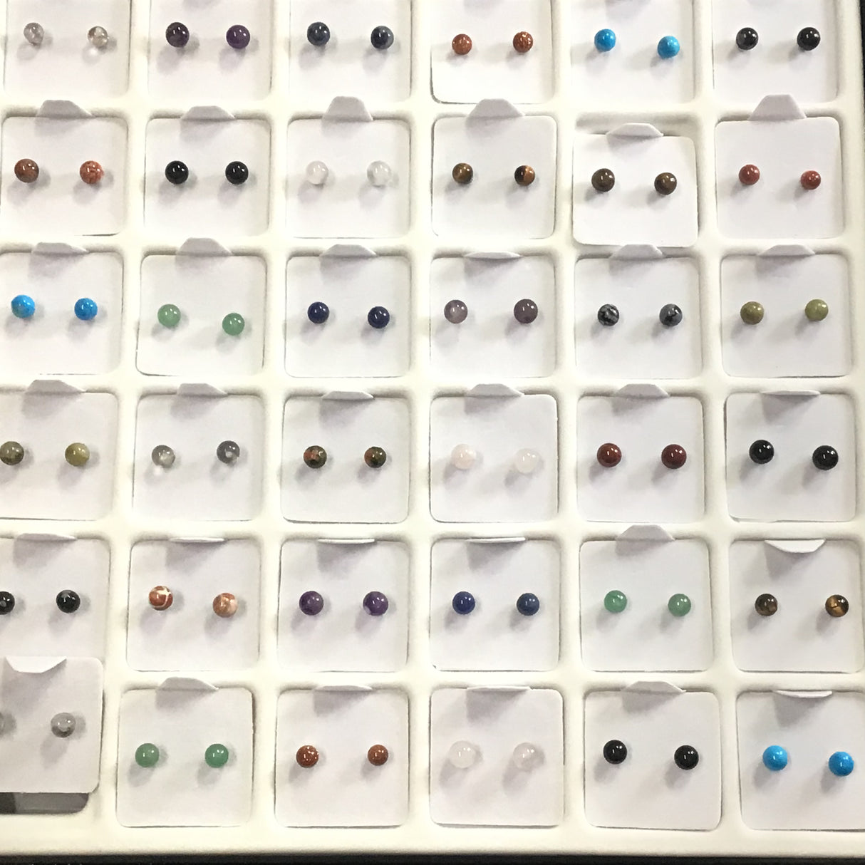 Gemstone studs 4mm rounds display grid with many colored stone pairs including turquoise, amethyst, tiger's eye and onyx