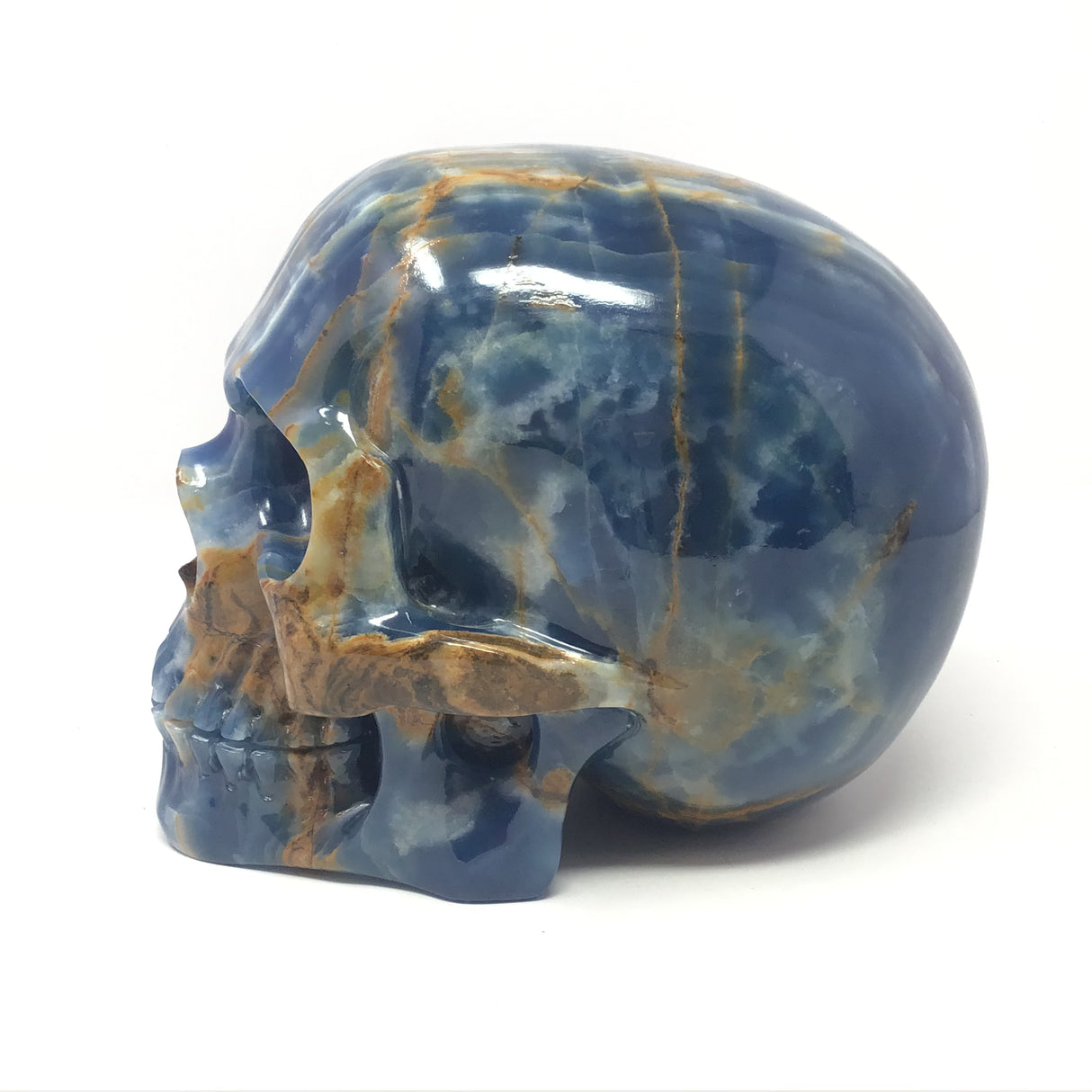 Blue Calcite Skull Carving with Woody Grains on Right Side