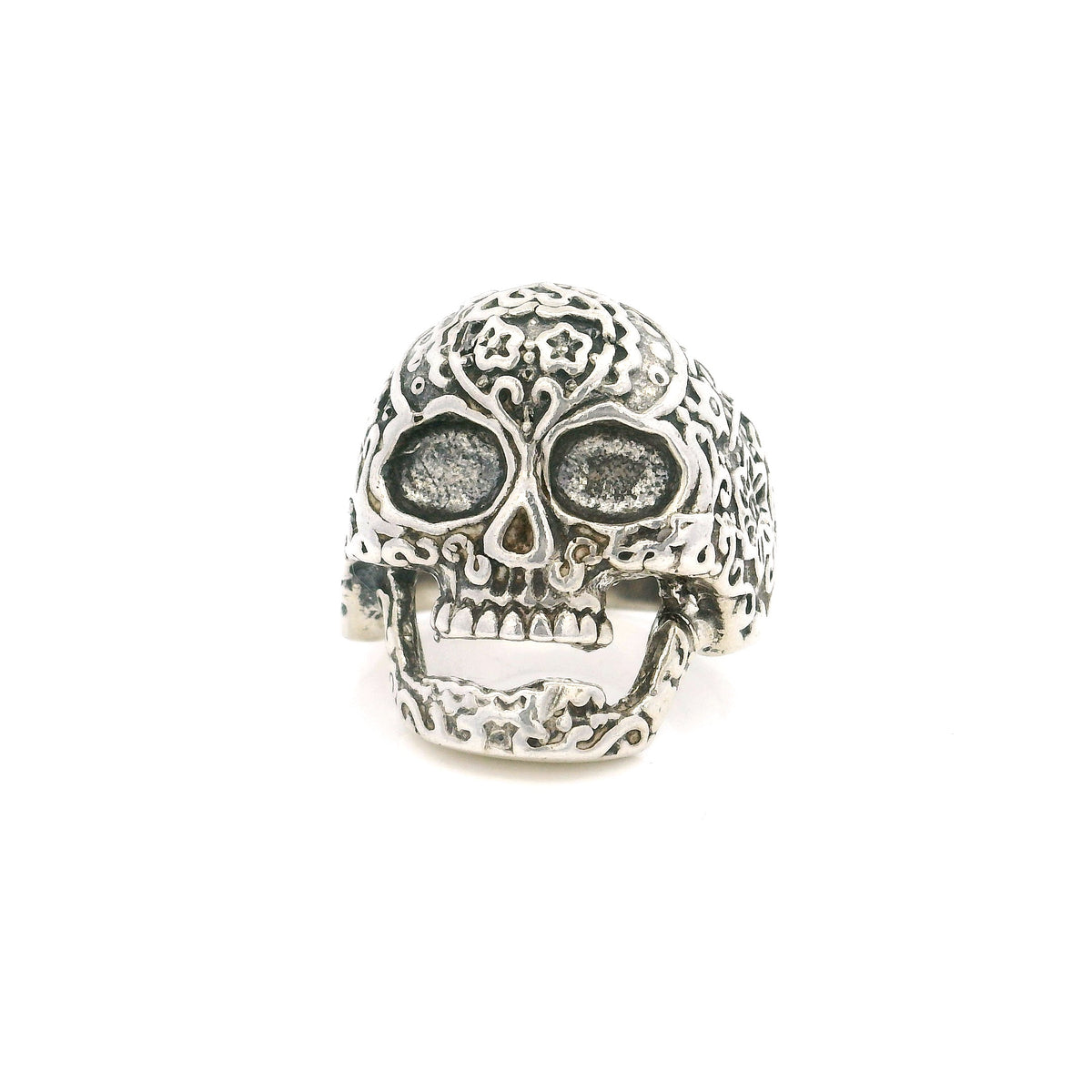 Sterling silver sugar skull ring with floral engraved detail and hollow eye sockets, front view