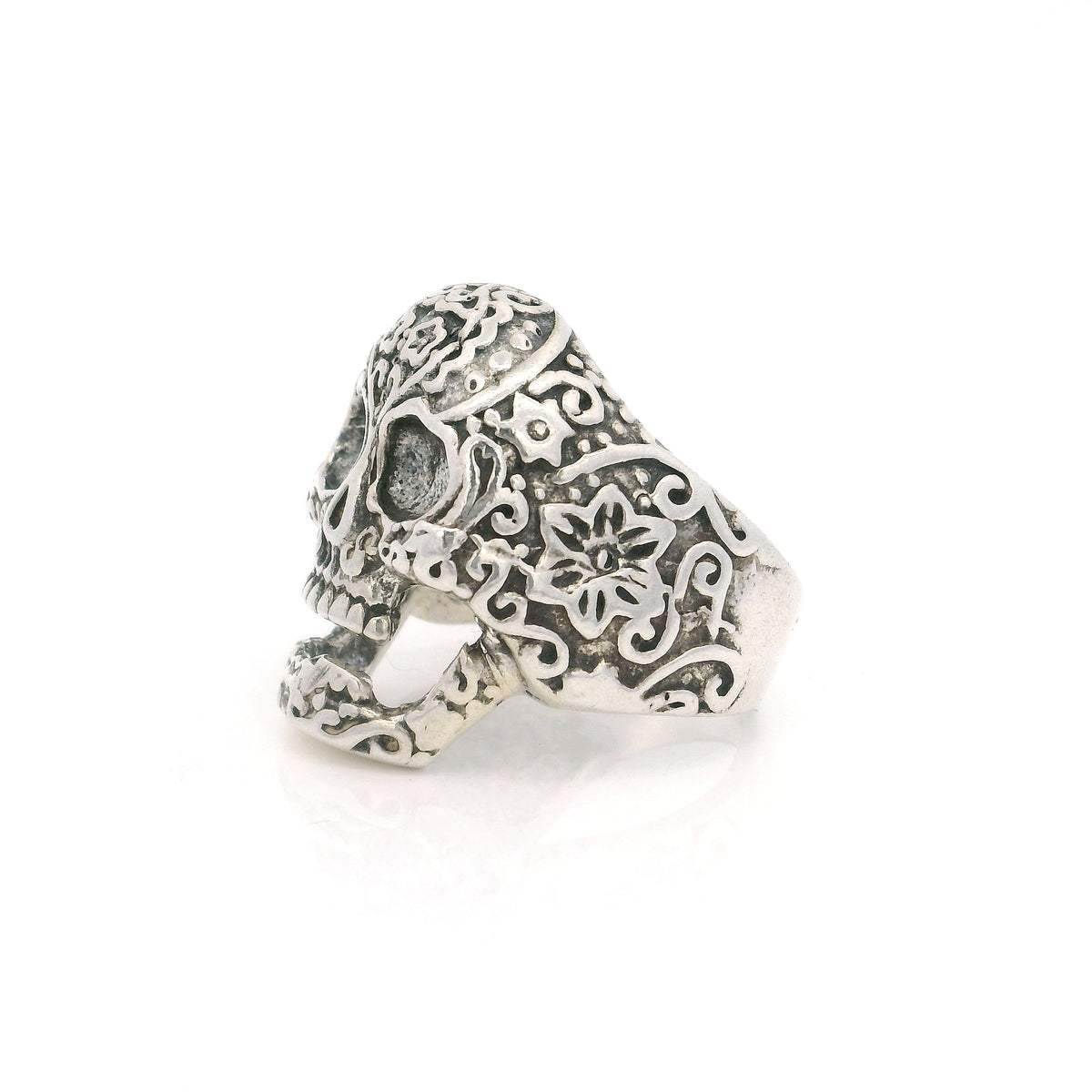 Sterling silver sugar skull ring, side view showing floral scrollwork across the skull