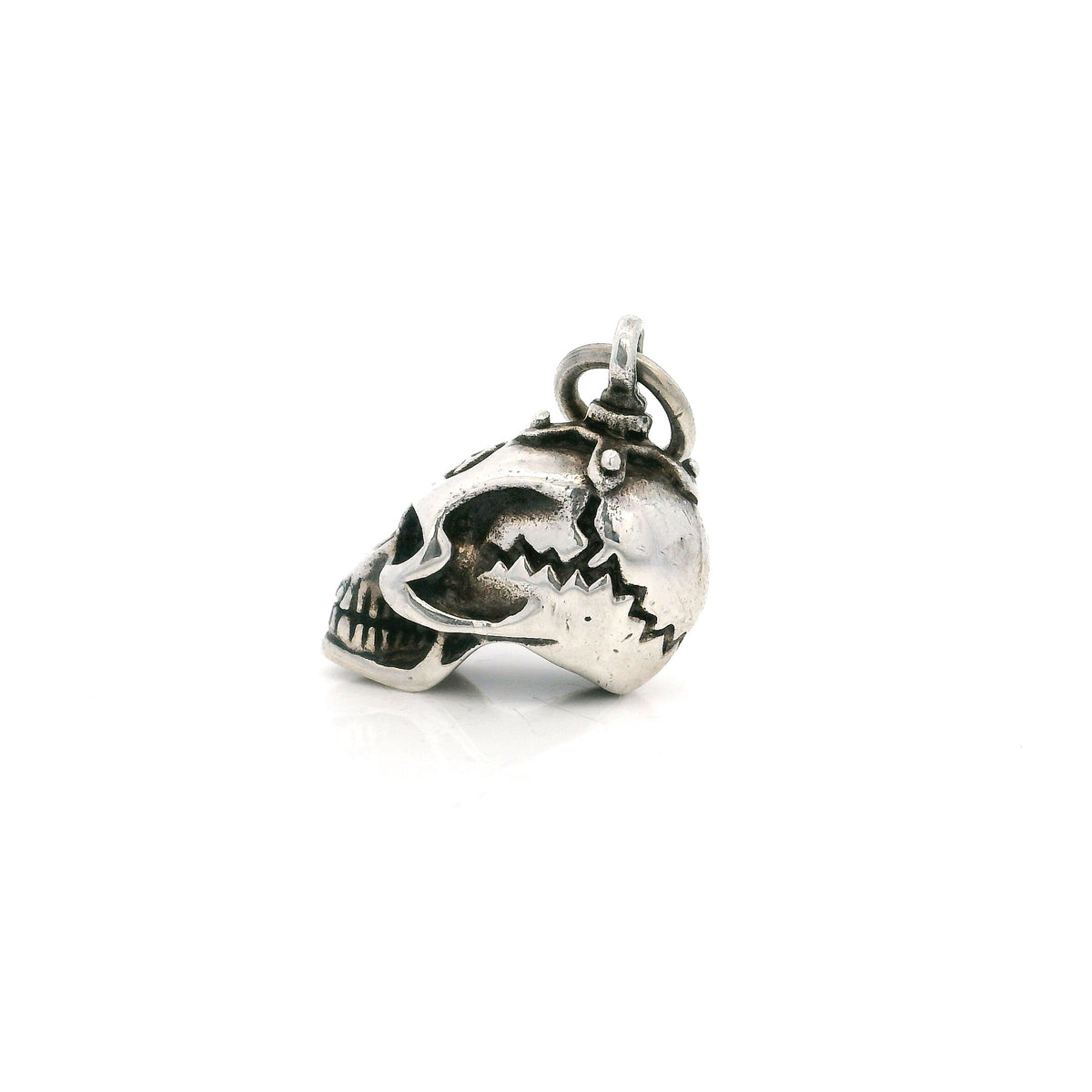 Sterling silver skull pendant side profile showing cracked cranium detail
