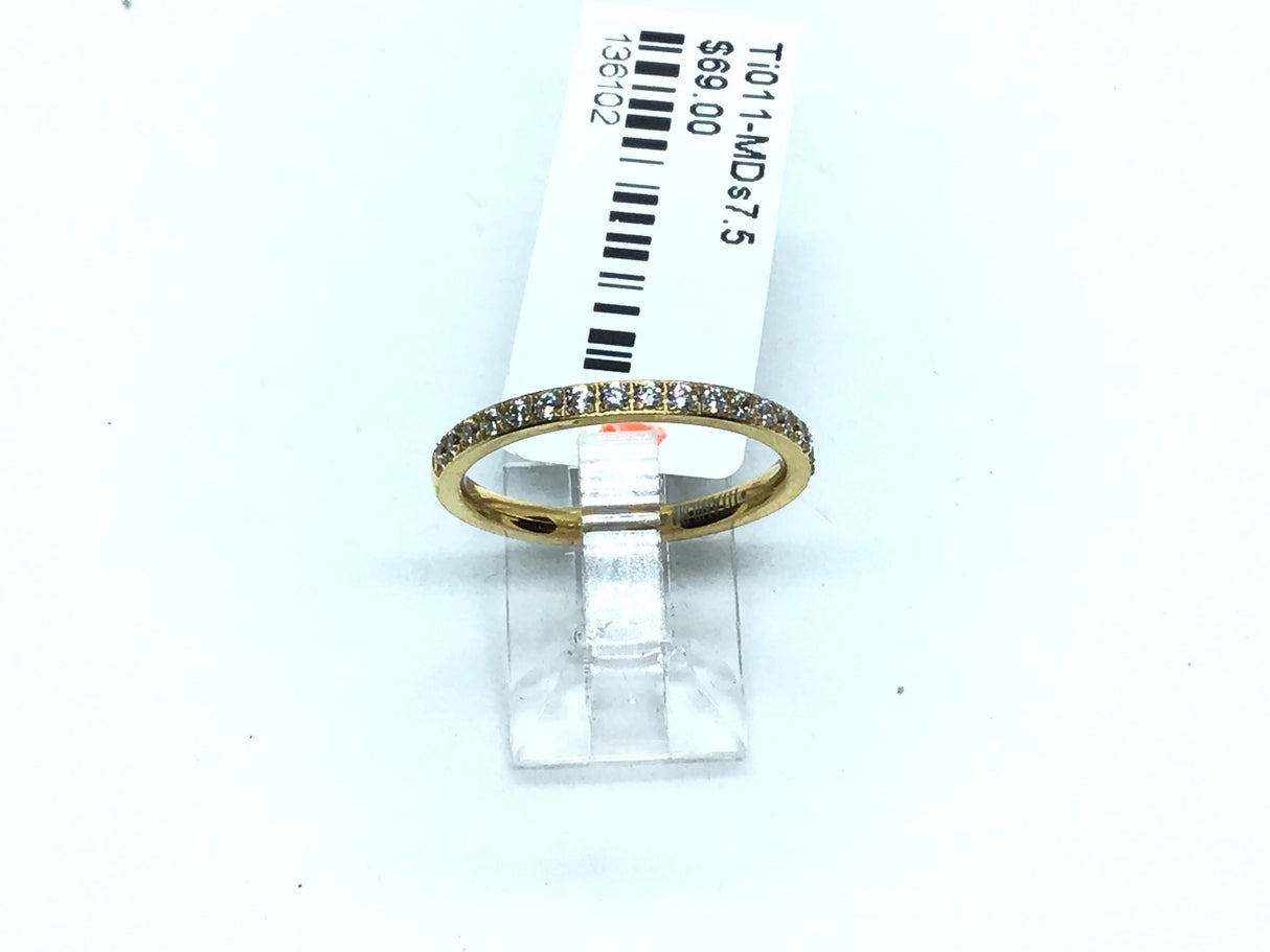 Thin gold-tone titanium band lined with white cubic zirconia pave along the crown