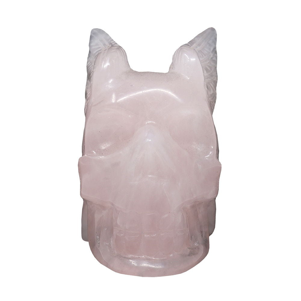 Rose quartz skull with wings carving, front view with wings flared behind