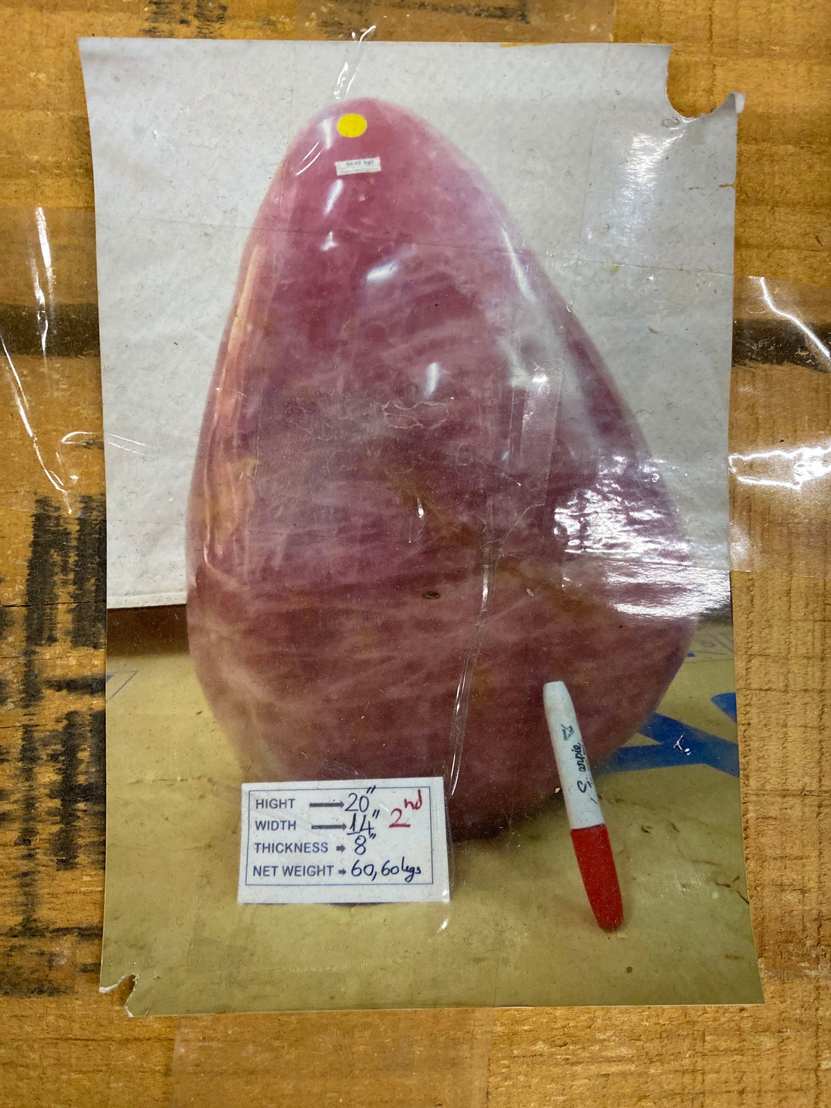 Supplier reference photo of a raspberry rose quartz freeform with a card listing 20 inch height