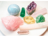 Collection of various crystals and gemstones on a white surface