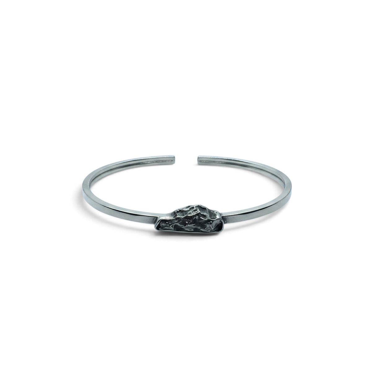 Rare Earth Gallery Campo De Cielo meteorite cuff bracelet featuring a rough freeform stone in a silver bezel setting.