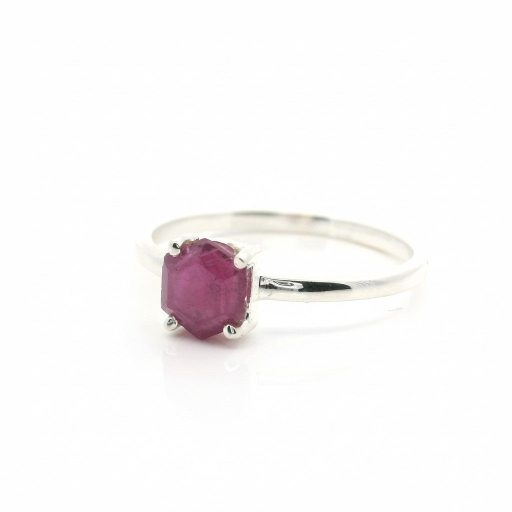 Rare Earth Gallery faceted ruby stalactite ring in a silver prong setting, size 11, isolated on a white background.