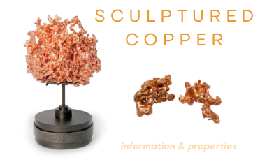 Sculptured Copper — branching native copper specimen on a stand beside two shiny copper nuggets