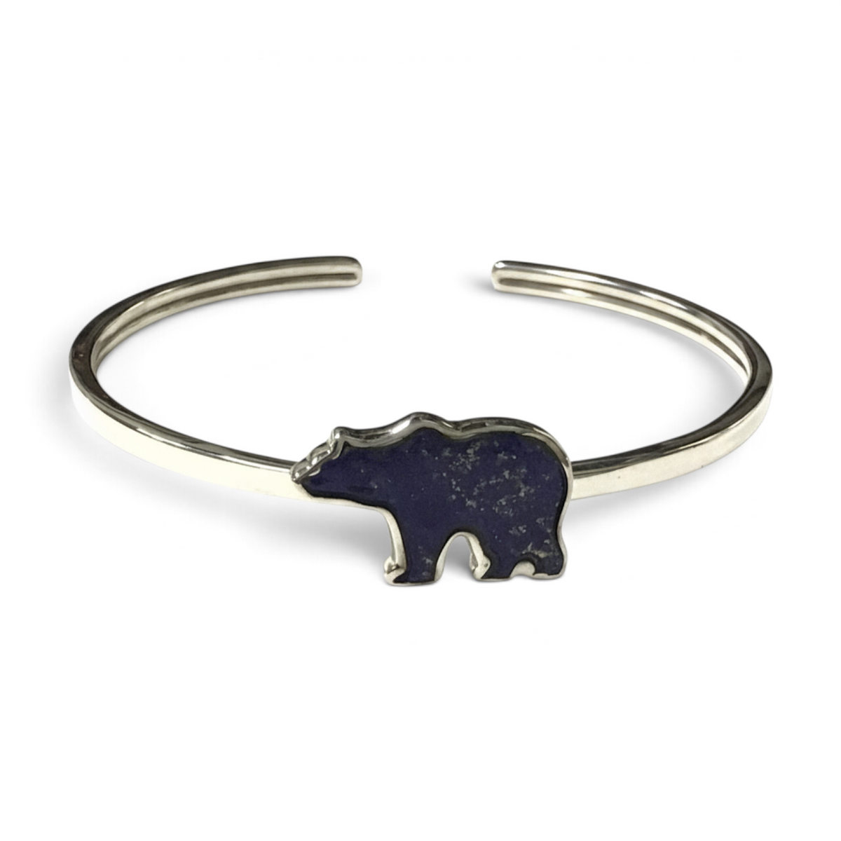 Rare Earth Gallery lapis lazuli twist bangle bracelet featuring a grizzly bear inlay with a polished silver bezel.