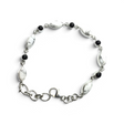 Rare Earth Gallery link bracelet featuring oval howlite and round black onyx cabochons set in 925 sterling silver.