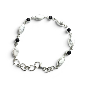 Rare Earth Gallery link bracelet featuring oval howlite and round black onyx cabochons set in 925 sterling silver.