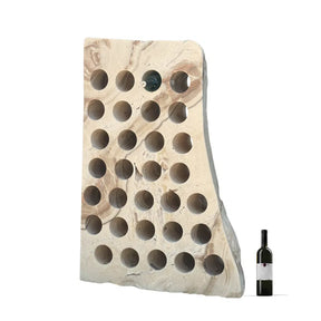 Miel Onyx wine rack featuring 31 holes, with a natural stone finish and a wine bottle for scale.
