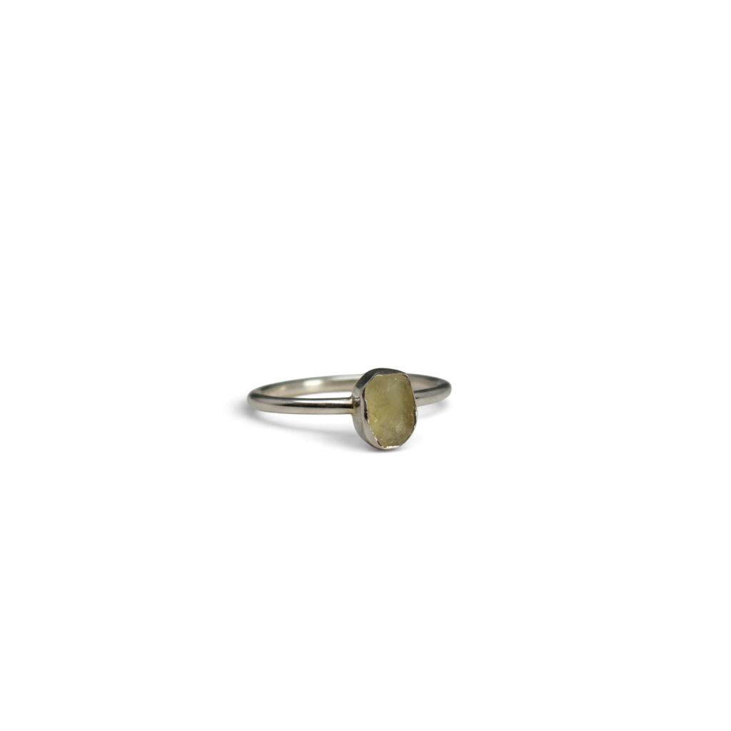Rare Earth Gallery ring featuring a raw golden Libyan Desert Glass tektite in a minimalist 925 sterling silver bezel.
