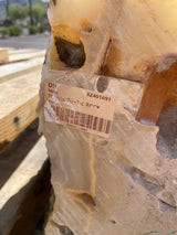 Detail of the Tekkis Ice Onyx fountain stone showing amber inclusions and the taped Tequix rustic rock label