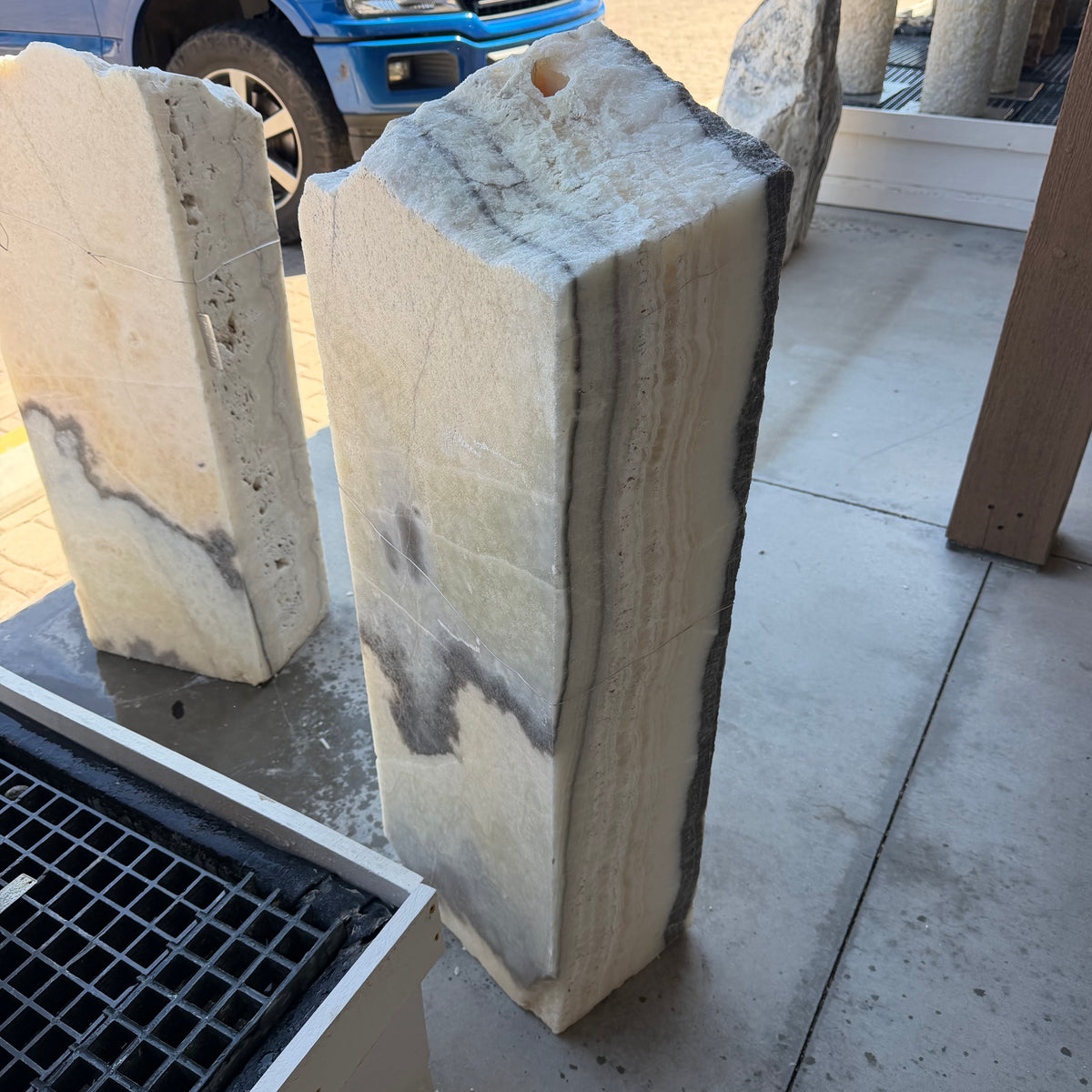 Cream banded side of the black and white onyx column fountain with a drilled top opening