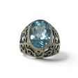 Rare Earth Gallery blue topaz ring featuring a faceted oval stone on a rhodium dome band with heart cutouts