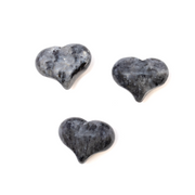 Three voluptuous larvikite hearts with puffy curves and grey black feldspar flash on white