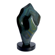 Rainbow sheen obsidian freeform sculpture with green-blue-gold swirls and deep hollow on round black base