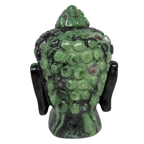 Green stone Buddha head sculpture on a white background