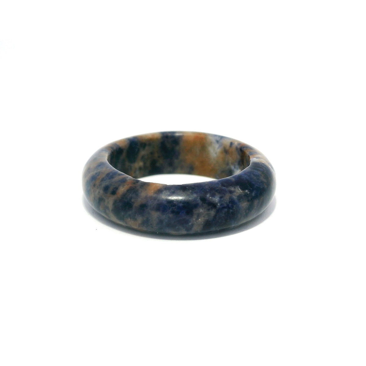 Sodalite gemstone band ring with deep blue and tan mottling, carved from solid stone