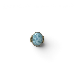 Rare Earth Gallery oval larimar cabochon ring with a silver braided bezel and gold heart detail on an oxidized band.