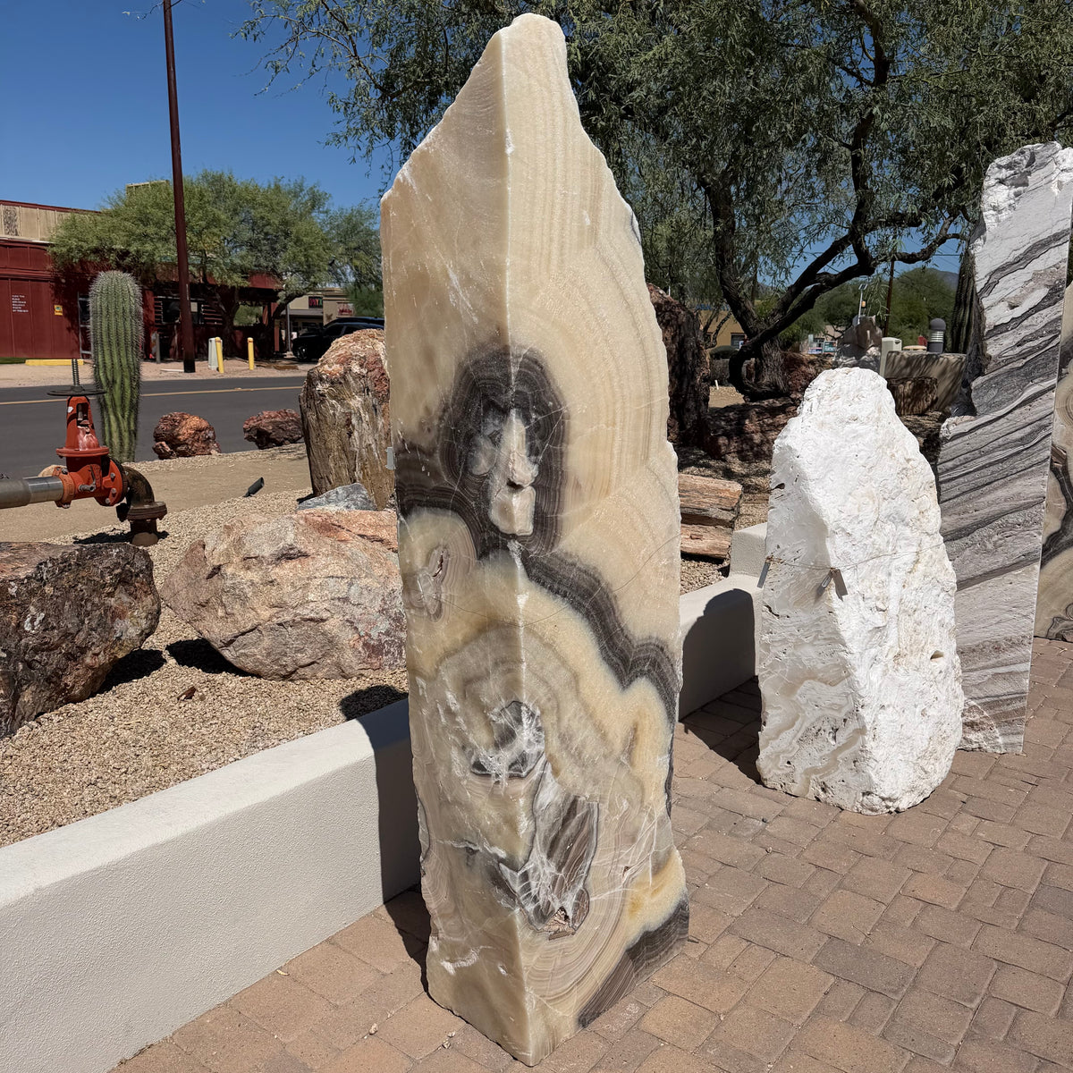 Yellow orange cosmic zebra onyx tapered pillar fountain with bold brown and cream swirl bands