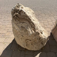 Chocolate travertine onyx boulder fountain set on pavers, swirled tan and brown layering