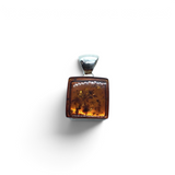 Rare Earth Gallery square cognac amber pendant featuring a polished silver hinge bar bail on a white background.