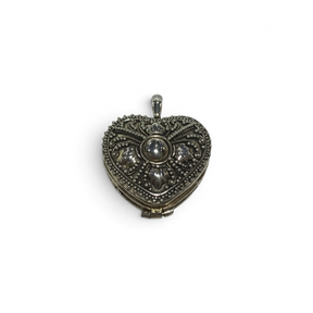 Rare Earth Gallery sterling silver heart locket featuring intricate beaded filigree and floral embossed details.
