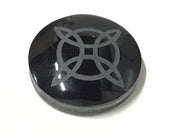 Black obsidian cabochon etched with a medieval Celtic knot sacred geometry design, high-gloss domed top
