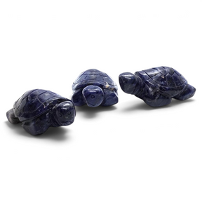 Three Rare Earth Gallery sodalite sea turtle carvings with deep blue stone texture and polished finish