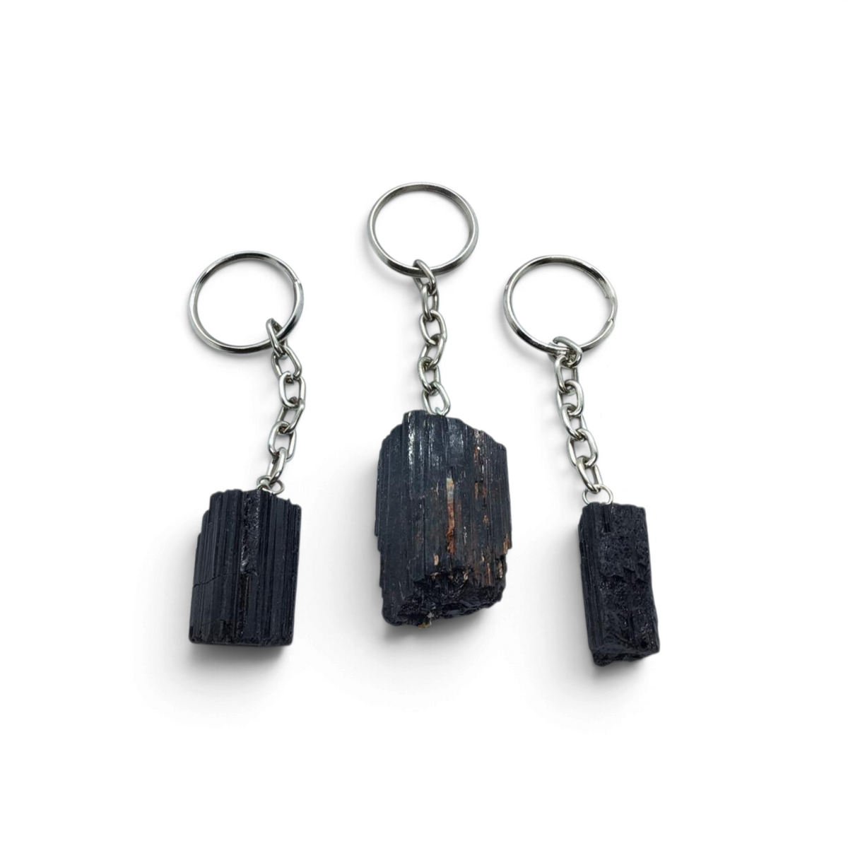 Rare Earth Gallery rough black tourmaline crystal keychains with silver-tone metal rings on a white background.