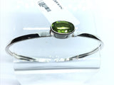 View of Faceted Peridot Twist Bracelet - East-west Set Oval With Tall Silver Bezel