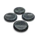 Four polished Kambaba Jasper palm stones with thumb divots, dark green and black, grouped on white