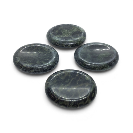 Four polished Kambaba Jasper palm stones with thumb divots, dark green and black, grouped on white