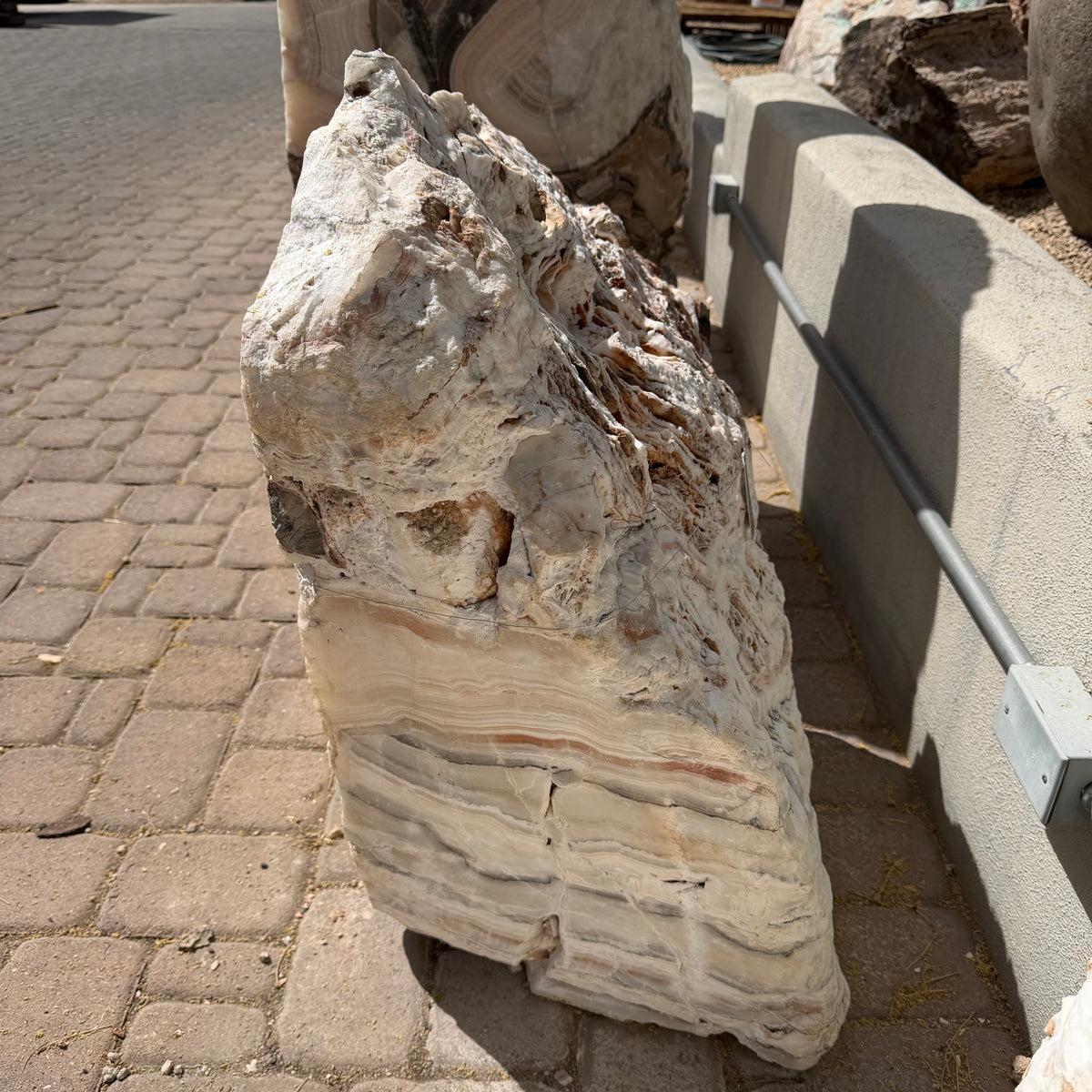 Side view of the Sunset Fossil Onyx fountain showing its cut faces and horizontal cream banding
