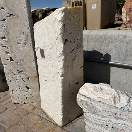 Side profile of the white fossil onyx rectangle column showing its slab thickness and pitted fossil texture