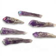 Six Bahia amethyst crystal points with purple tips marked by colored polka-dot stickers on white